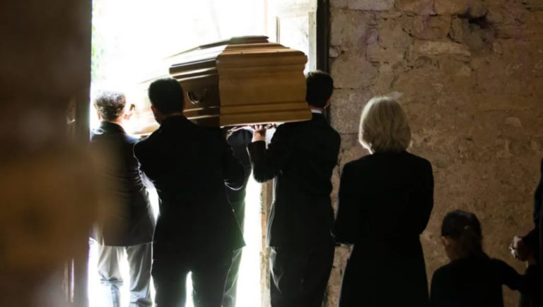 Family Following Coffin From Church